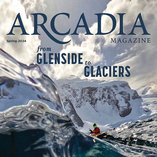 The cover of the Spring 2024 edition of Arcadia Magazine with a kayaker paddling through the ocean.
