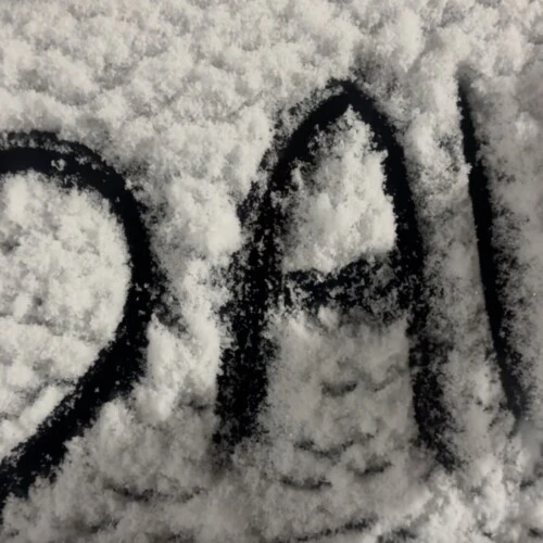 Handwriting in the snow showing heart shape next to AU