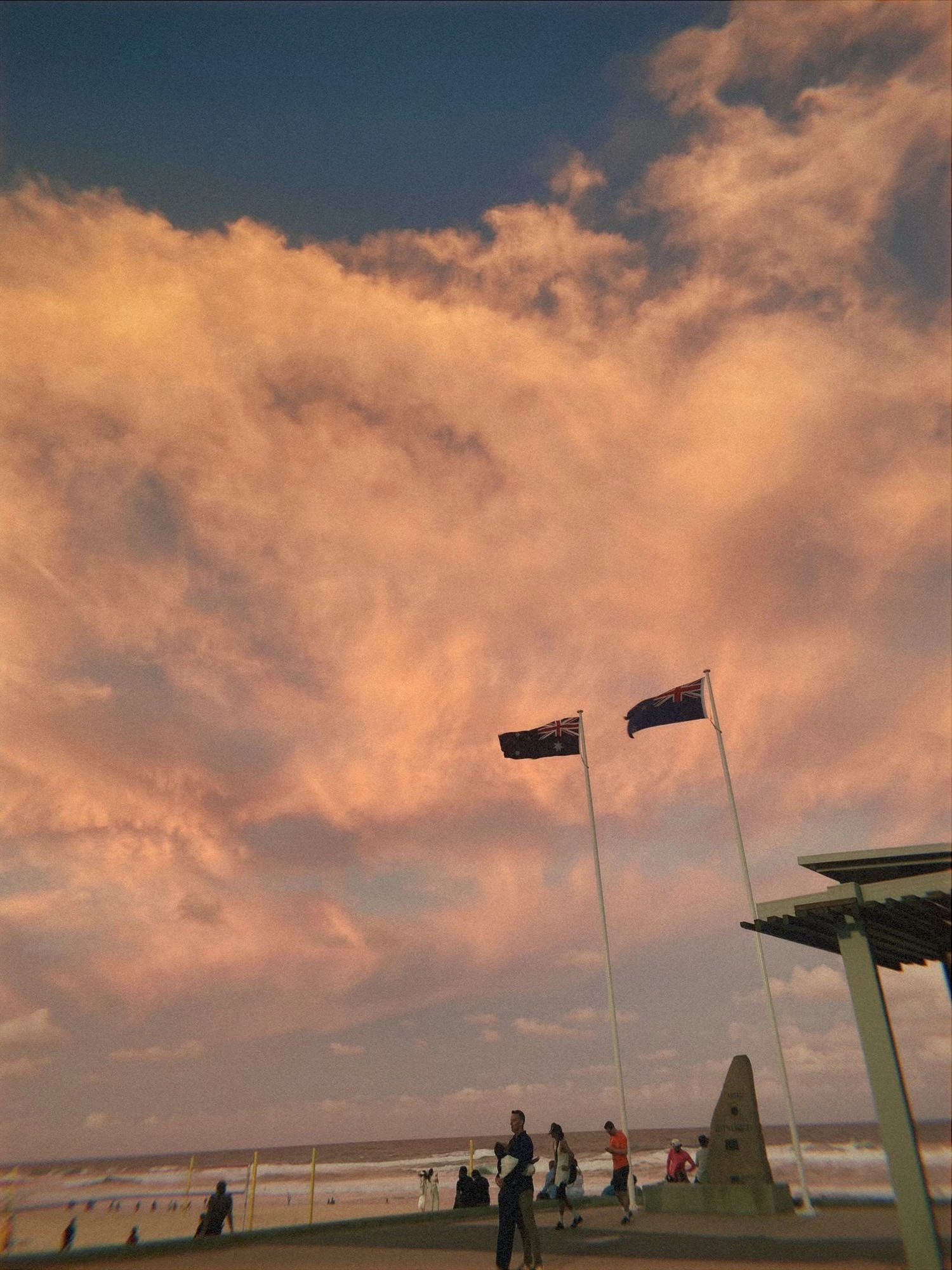 Two flagpoles with Australian flags on them.