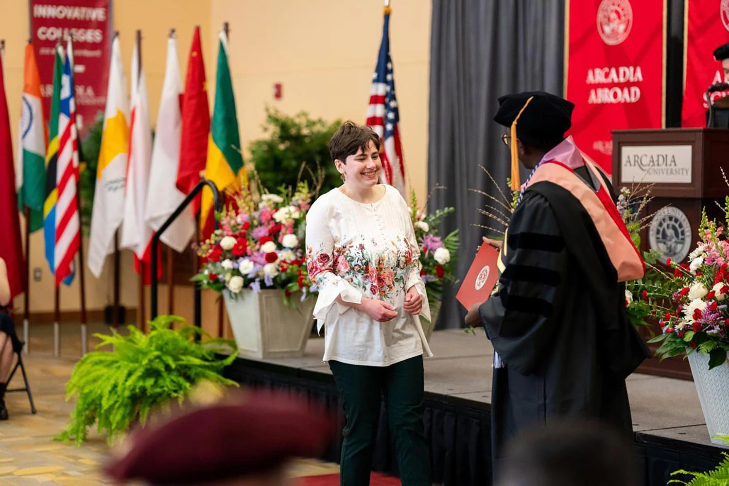Dean Otieno presenting Julianna Reidell ’25 with one of her three awards.
