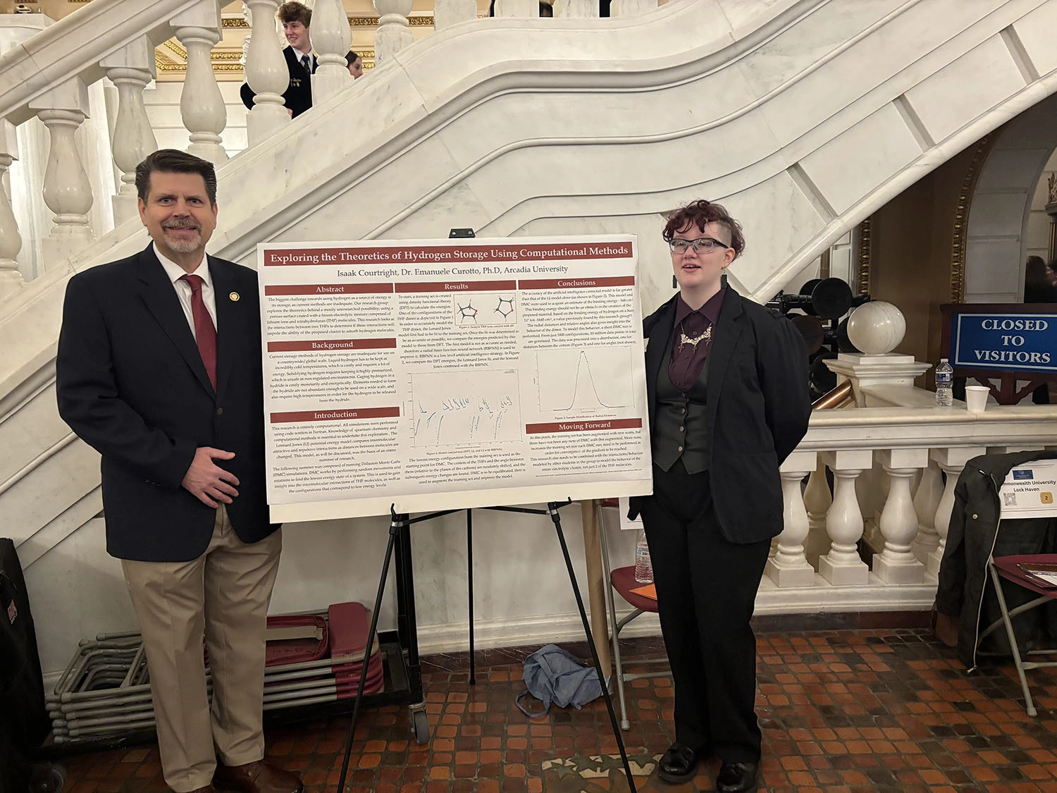 Isaak Courtright ’26 and Representative Jeff Olsommer next to Courtright's presentation board.