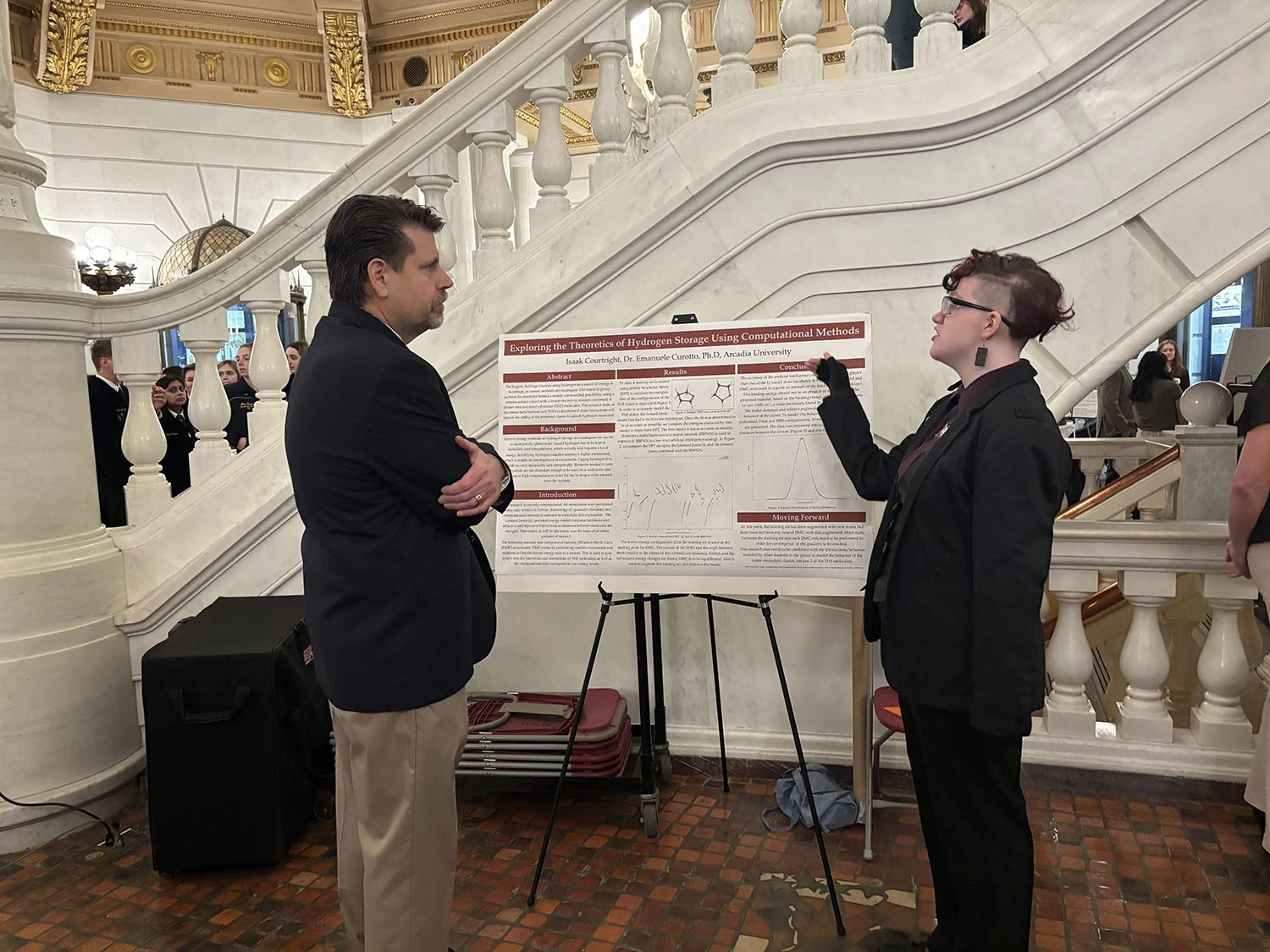Isaak Courtright ’26 explaining his research to Representative Jeff Olsommer.