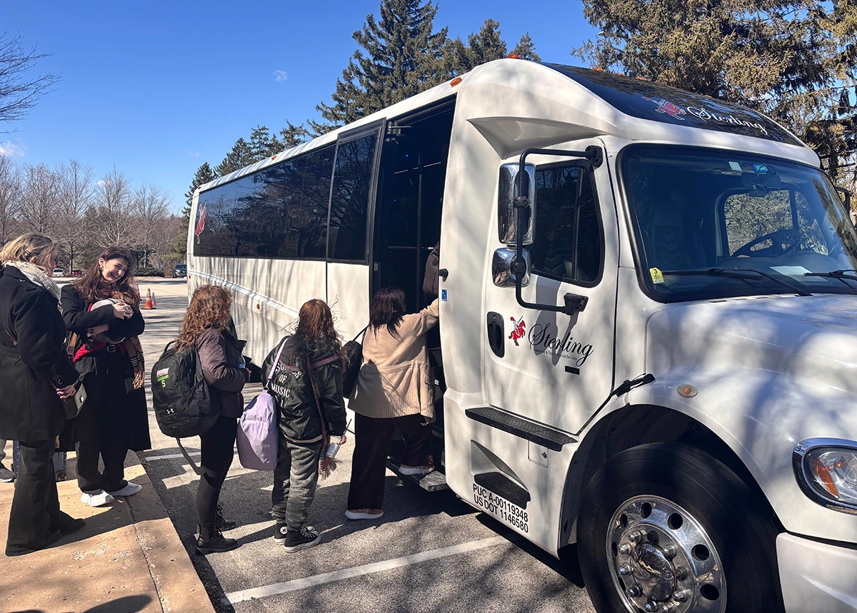Students board transportation to the airport