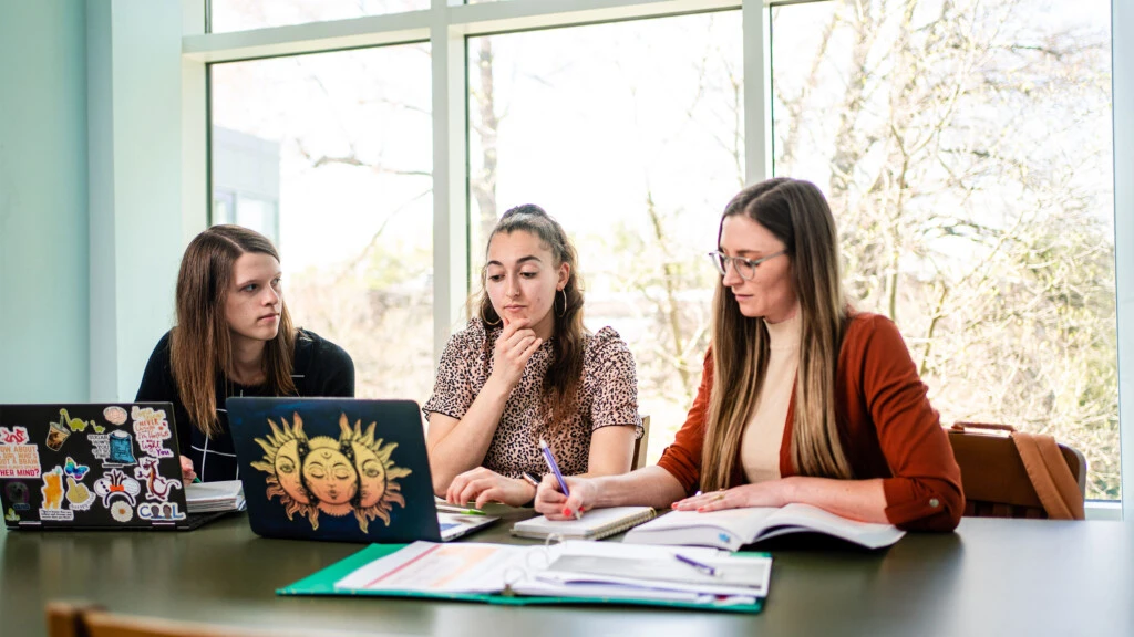 Three students studying in the library together