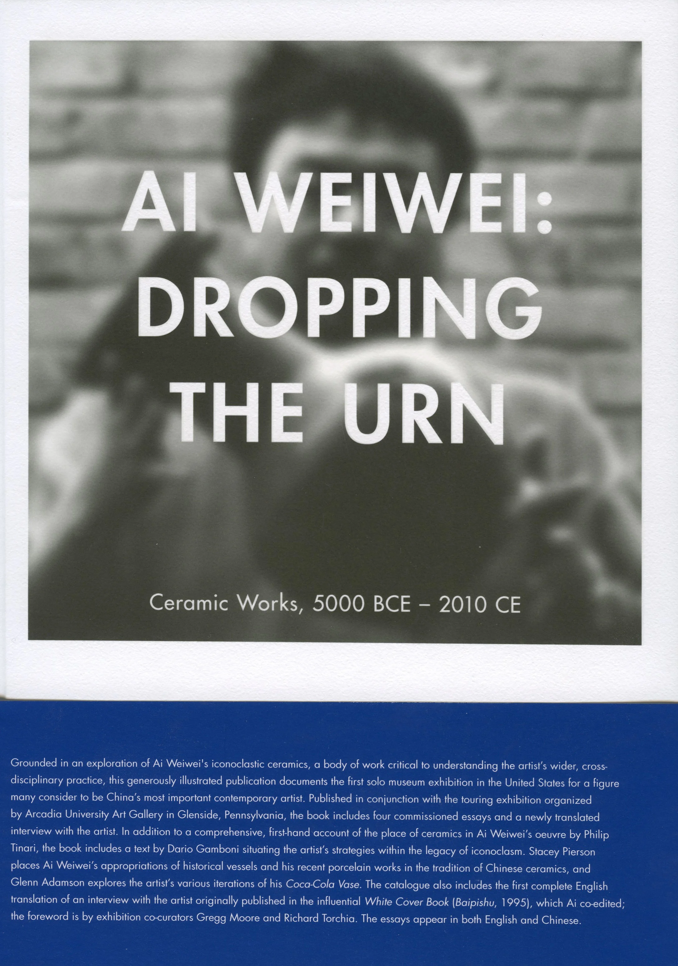 Cover of "Ai Weiwei: Dropping the Urn," blurry black and white photo with title superimposed. Blue description text underneath. 