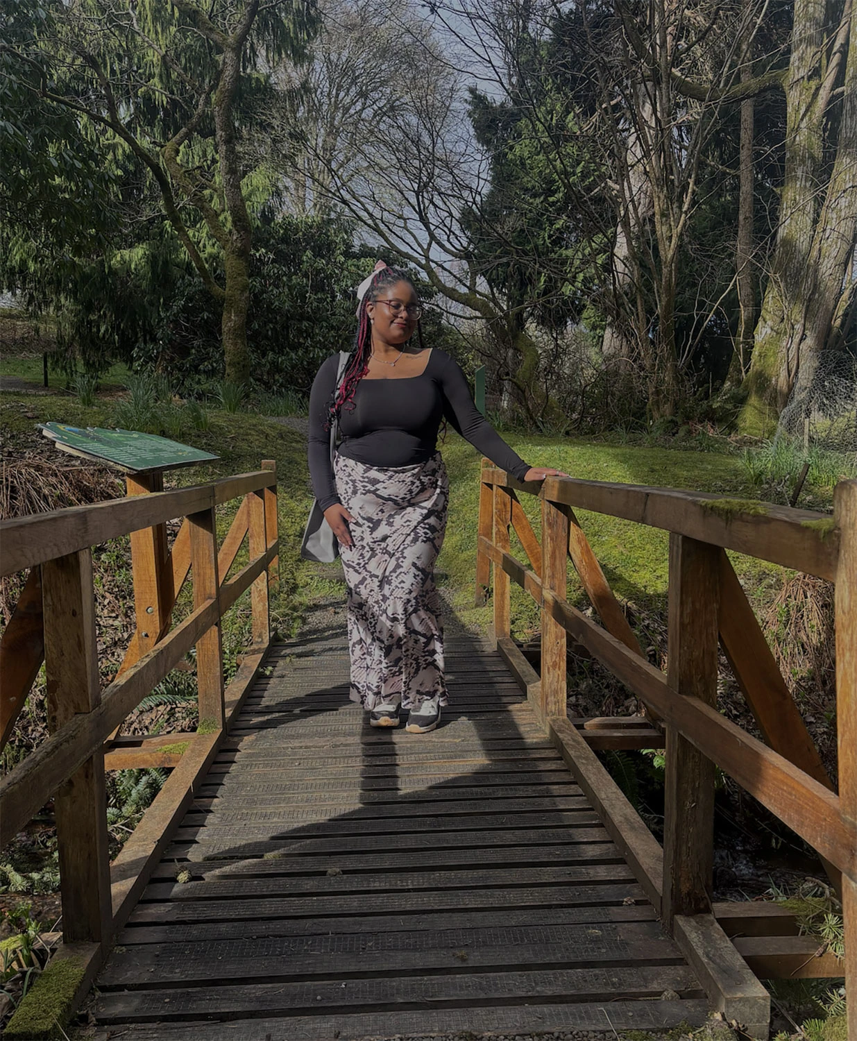 Makiyah Smith ’28 on a wooden bridge.