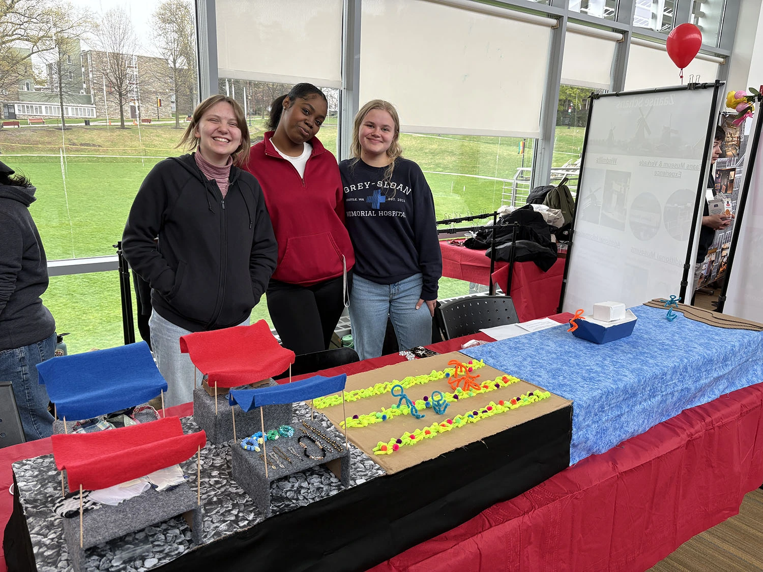 Students showing a model they created at Global Expo.