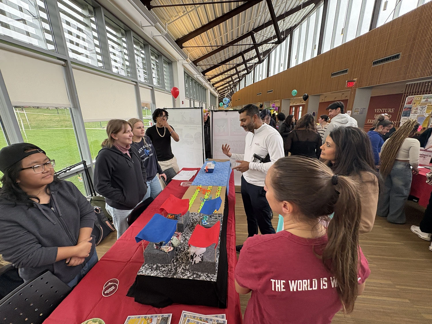 President Nair speaking with students at Global Expo.