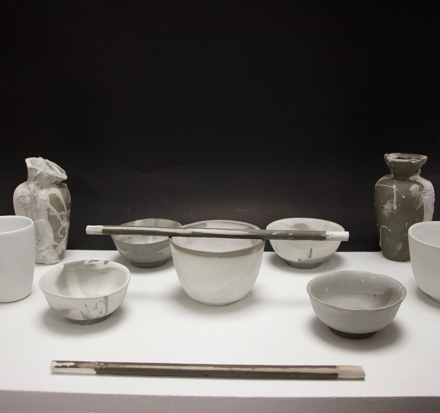 An array of bowls and pots set on a table.