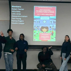 SAJE Fellows standing in front of their presentation.